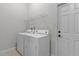 Laundry room with white washer and dryer, wire shelving, and a door at 1018 Green Gate Blvd, Groveland, FL 34736
