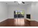 Living room with hardwood floors, fireplace, and sliding glass doors at 1018 Green Gate Blvd, Groveland, FL 34736