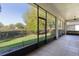 Relaxing screened patio overlooking a manicured lawn and mature trees at 1018 Green Gate Blvd, Groveland, FL 34736
