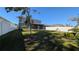 Spacious backyard featuring a manicured lawn, providing privacy and room for recreation at 1710 Summer Rose Dr, Mount Dora, FL 32757