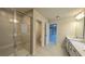 Bright bathroom showcasing a glass shower, dual vanity, and access to another room at 1710 Summer Rose Dr, Mount Dora, FL 32757
