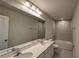 Bathroom with double sinks, large mirror, and tub at 1710 Summer Rose Dr, Mount Dora, FL 32757