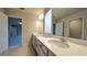 Bathroom featuring dual sinks, granite countertops, and modern fixtures at 1710 Summer Rose Dr, Mount Dora, FL 32757