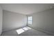 A well-lit bedroom with neutral tones and a window providing natural light at 1710 Summer Rose Dr, Mount Dora, FL 32757