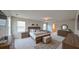 A large bedroom featuring ample natural light from large windows and neutral carpeting at 1710 Summer Rose Dr, Mount Dora, FL 32757