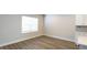 A bright bedroom with wood-look flooring, and a window with natural light at 1710 Summer Rose Dr, Mount Dora, FL 32757