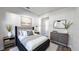 Relaxing bedroom boasts a plush bed, neutral decor, and ample natural light for a serene atmosphere at 1710 Summer Rose Dr, Mount Dora, FL 32757
