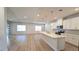 Spacious open-concept kitchen with white cabinets, large island, and natural light at 1710 Summer Rose Dr, Mount Dora, FL 32757