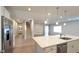 Bright, open kitchen with white cabinets, stainless appliances, and a center island perfect for entertaining at 1710 Summer Rose Dr, Mount Dora, FL 32757