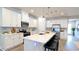 Bright, open kitchen features white cabinets, stainless steel appliances, and a large center island with bar seating at 1710 Summer Rose Dr, Mount Dora, FL 32757