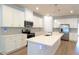 Elegant kitchen with white cabinets, a center island, and stainless steel appliances, offering a modern design at 1710 Summer Rose Dr, Mount Dora, FL 32757