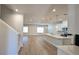 Open concept kitchen and living area with white cabinets, island, and modern appliances at 1710 Summer Rose Dr, Mount Dora, FL 32757