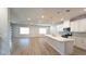 Spacious open-concept kitchen with white cabinets, large island, and natural light at 1710 Summer Rose Dr, Mount Dora, FL 32757