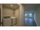 Convenient laundry area with modern washer and dryer, located next to a spacious living area at 1710 Summer Rose Dr, Mount Dora, FL 32757