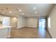 Open-concept living area with recessed lighting, wood floors, staircase, and glass sliding doors to the backyard at 1710 Summer Rose Dr, Mount Dora, FL 32757