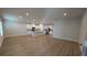 Spacious living room and kitchen layout with recessed lighting, white cabinets, and stainless steel appliances at 1710 Summer Rose Dr, Mount Dora, FL 32757