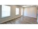Spacious living room with large windows and wood-look flooring at 1710 Summer Rose Dr, Mount Dora, FL 32757