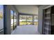 Spacious screened patio with a view of the well-maintained, green backyard and white fence at 1710 Summer Rose Dr, Mount Dora, FL 32757