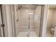 Luxurious glass shower with built-in seating and sleek tile design at 1710 Summer Rose Dr, Mount Dora, FL 32757
