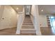 Staircase to the second floor features neutral carpet and white railings, creating a clean and inviting transition at 1710 Summer Rose Dr, Mount Dora, FL 32757