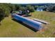 Aerial view of two hoop greenhouses on a large property at 17100 Se 156Th Place Rd, Weirsdale, FL 32195