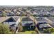 Aerial view showing a two-story house with solar panels and a screened enclosure at 1741 Bonser Rd, Minneola, FL 34715