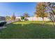 Large grassy backyard with a privacy fence and patio area at 1741 Bonser Rd, Minneola, FL 34715