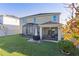 Two-story home with screened porch and grassy backyard at 1741 Bonser Rd, Minneola, FL 34715
