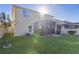Home's back features a screened porch and grassy yard at 1741 Bonser Rd, Minneola, FL 34715
