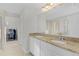 Double vanity bathroom with granite countertop and a large mirror at 1741 Bonser Rd, Minneola, FL 34715