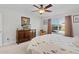 Bright bedroom with a dresser, TV, and window coverings at 1741 Bonser Rd, Minneola, FL 34715