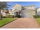 Two-story house with brick driveway and landscaped lawn at 1741 Bonser Rd, Minneola, FL 34715