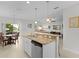 Open kitchen with island, granite countertops, and stainless steel appliances at 1741 Bonser Rd, Minneola, FL 34715