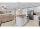 Open kitchen with island and stainless steel appliances at 1741 Bonser Rd, Minneola, FL 34715