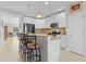 Modern kitchen with white cabinets, granite countertops, and breakfast bar at 1741 Bonser Rd, Minneola, FL 34715