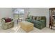 Living room with green sofa, armchair, and ottoman at 1741 Bonser Rd, Minneola, FL 34715