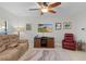 Cozy living room featuring a comfortable couch and a large TV at 1741 Bonser Rd, Minneola, FL 34715