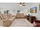 Relaxing living room featuring reclining sofas and a large TV at 1741 Bonser Rd, Minneola, FL 34715