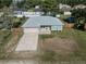 Light teal house with gray roof, attached garage, and fenced yard at 1761 12Th St, Orange City, FL 32763
