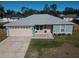 Newly constructed teal home with attached garage and well-maintained lawn at 1761 12Th St, Orange City, FL 32763