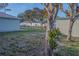 A spacious backyard featuring green grass, mature trees, and partial fencing at 1761 12Th St, Orange City, FL 32763