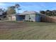 Exterior shot of a single-story home with a well-maintained lawn and attached garage at 1761 12Th St, Orange City, FL 32763