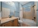 Bright bathroom with tub-shower, vanity, and tiled walls and flooring at 1828 Feliciana Ter, The Villages, FL 32162