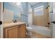 Bright bathroom with tub-shower, vanity, and tiled walls and flooring at 1828 Feliciana Ter, The Villages, FL 32162