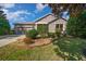 Charming single-story home featuring a well-manicured lawn and an attached two-car garage at 1828 Feliciana Ter, The Villages, FL 32162