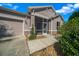 The house features a screened front entry, an attached garage, and manicured landscaping at 1828 Feliciana Ter, The Villages, FL 32162