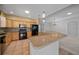 Open kitchen with stainless steel appliances, breakfast bar, and pendant lighting at 1828 Feliciana Ter, The Villages, FL 32162