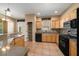 Kitchen with wooden cabinets, tile backsplash, and stainless steel appliances at 1828 Feliciana Ter, The Villages, FL 32162
