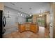 Kitchen and living room featuring granite countertops, tile floors, and modern appliances at 1828 Feliciana Ter, The Villages, FL 32162