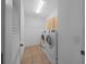 Laundry room with tile floor, modern washer and dryer, and storage cabinets at 1828 Feliciana Ter, The Villages, FL 32162